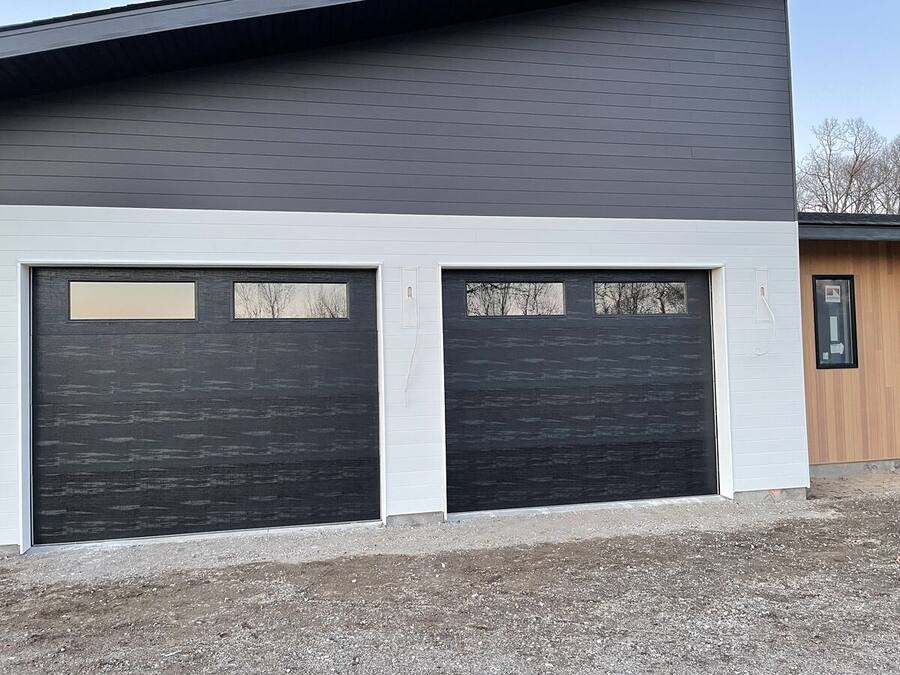 Modern black garage doors on a two-car garage